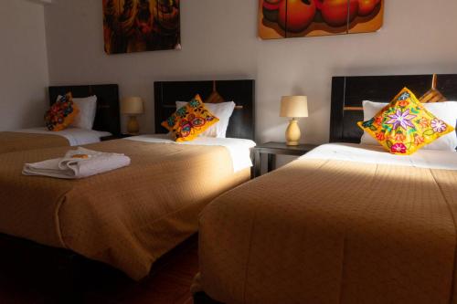 Ένα ή περισσότερα κρεβάτια σε δωμάτιο στο Hostal Pacha Inn