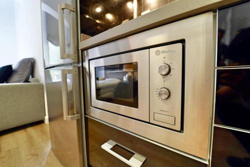 a microwave oven sitting on top of a counter at The Poet´s Corner Holiday Home in Triana