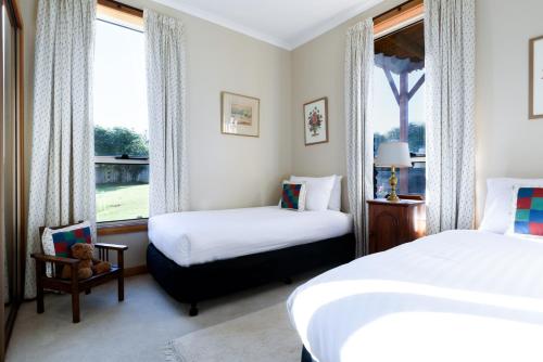 a hotel room with two beds and a window at Old-School Charm Meets Beachside Bliss in George Town