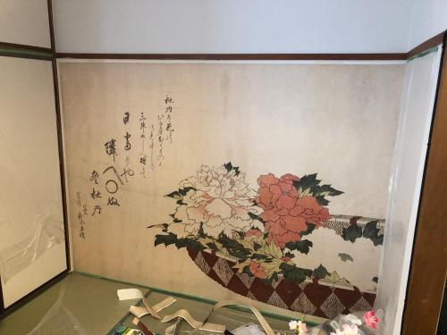 a wall with a painting of flowers on it at Station Front JUSO EAST 402 No Lift in Osaka
