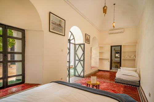 a bedroom with a bed and a window at Riad Akasia in Marrakech