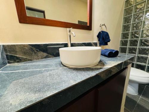 a bathroom with a sink and a toilet on a counter at Beach Getaway in Chuburná