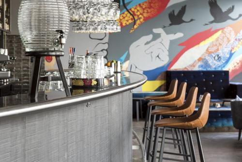 a bar with a row of stools in a restaurant at Comfort Hotel Göteborg in Gothenburg
