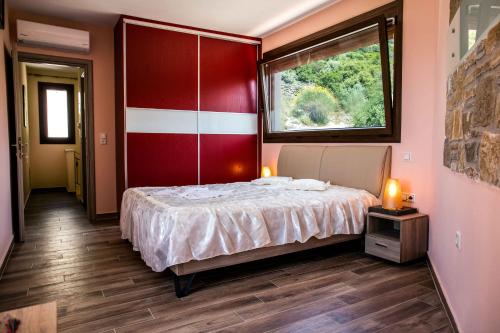 a bedroom with a large bed and a window at Aeri in Prinos