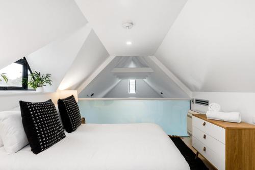 a bedroom with a white bed and a window at Arya in Byron Bay
