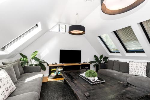 a living room with a couch and a tv at A Top Spot in Byron Bay