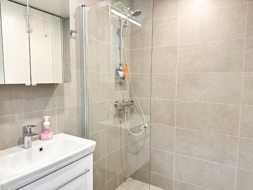 a bathroom with a shower and a sink at Apartment Kruuna in Kuopio