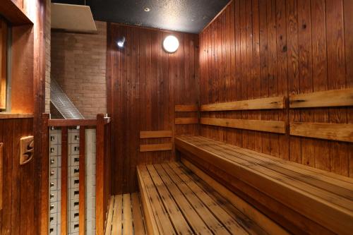 an empty sauna with wooden walls and wooden floors at Dormy Inn Premium Namba Natural Hot Spring in Osaka
