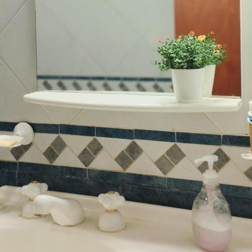 a bathroom sink with a bottle of soap and a plant at Casa Raíz in Villaguay