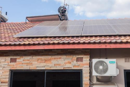 a group of solar panels on the roof of a house at Naya at Meanwood in Lusaka