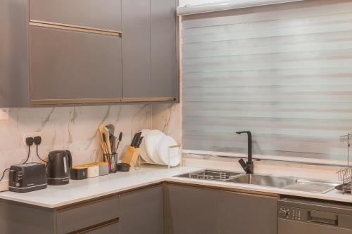 a kitchen with a sink and a counter top at Naya at Meanwood in Lusaka