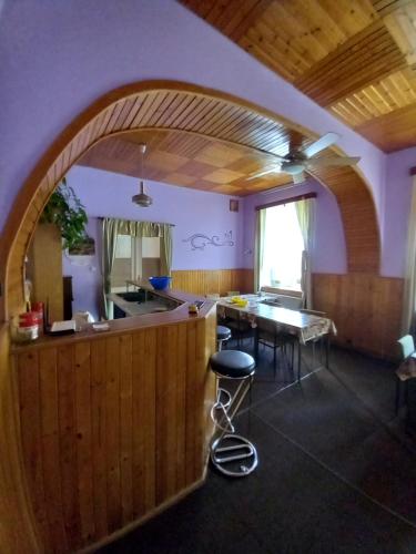a kitchen with an archway and a table and chairs at Pension V údolí v Jizerských horách in Josefuv dul