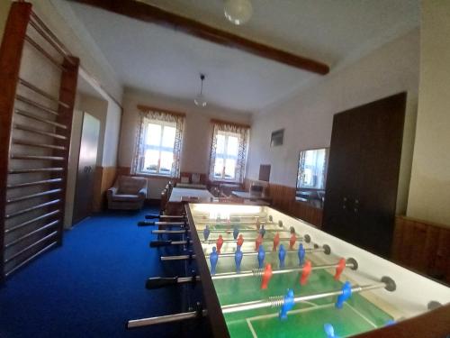 a room with a pool table and chairs at Pension V údolí v Jizerských horách in Josefuv dul