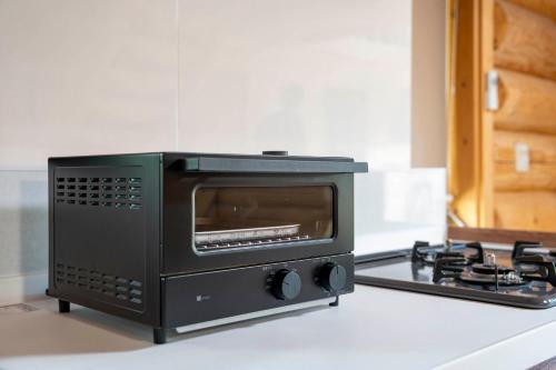 a black oven sitting on top of a kitchen counter at Lake Toya Moon Hills in Lake Toya