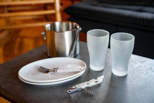 a table with a plate and two glasses and a knife at Lake Toya Moon Hills in Lake Toya