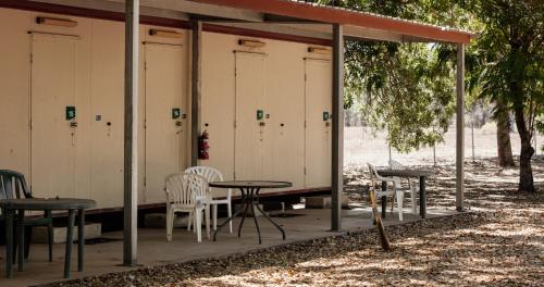 a row of stalls with tables and chairs in a park at BIG4 Breeze Holiday Parks - Katherine in Katherine