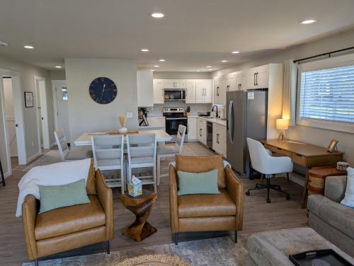 a kitchen and living room with a table and chairs at Reedsong Cottage in Hillsdale