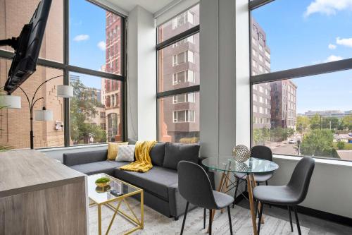a living room with a couch and a table at CozySuites At Presshouse in Pittsburgh