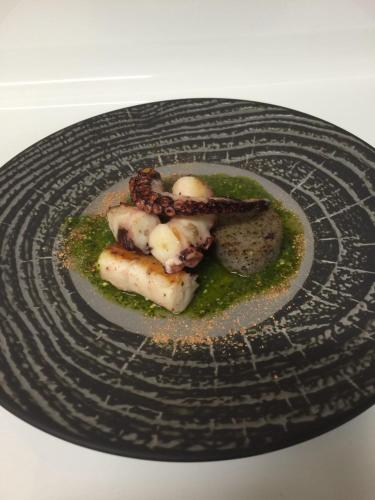 a plate of food on a white table at Hotel Maloia in Dubino