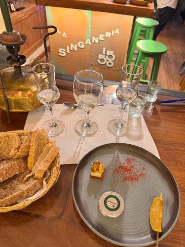 a table with a plate of bread and wine glasses at Casa Verde Hostal in Sucre