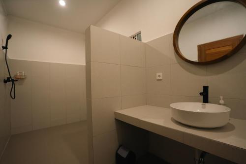 a bathroom with a sink and a mirror at Zena Surf Suite in Uluwatu