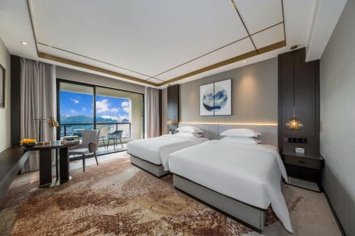 Postel nebo postele na pokoji v ubytování Poltton Century Hotel - Changtai Taoli Chunfeng Branch