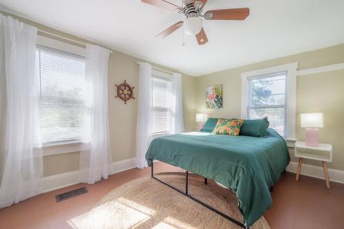 a bedroom with a bed and a ceiling fan at Serene Beachy Bungalow with Large Screened Porch! in Tampa