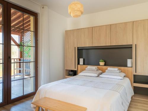 a bedroom with a large bed with a large headboard at Maison neuve à Sarlat avec jardin et terrasse - FR-1-616-488 in Sarlat-la-Canéda
