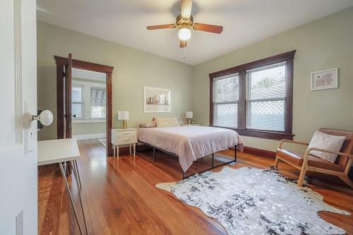 a bedroom with a bed and a ceiling fan at Historic & Cozy Bungalow by Downtown in Tampa
