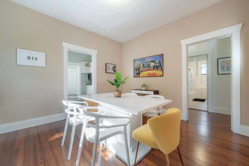 a dining room with a white table and chairs at Historic & Cozy Bungalow by Downtown in Tampa