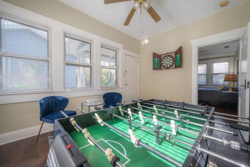 a ping pong table in a room with blue chairs at Historic & Cozy Bungalow by Downtown in Tampa
