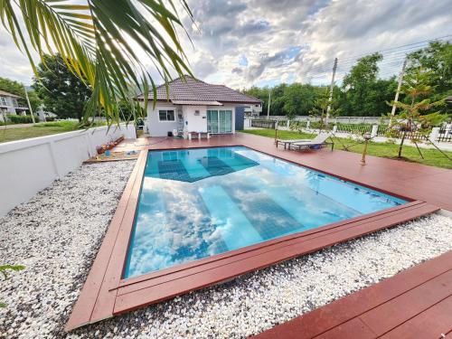 a swimming pool in the backyard of a house at Pool Villa - Phetchabun in Ban Yawi