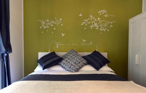 a bedroom with a bed with a green wall at Jubilee 2 in Rome