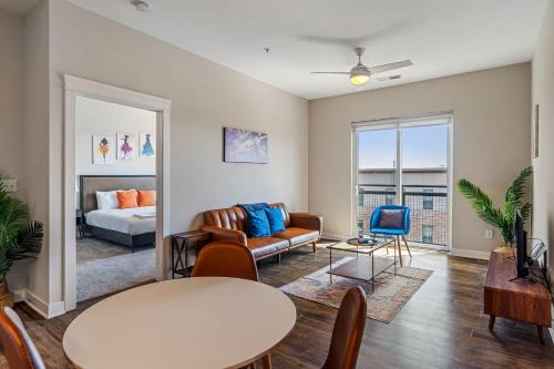 a living room with a couch and a table at CozySuites - Penrose On Mass with pool & parking #2 in Indianapolis