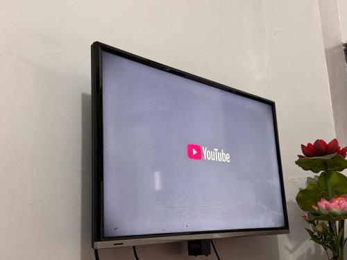 a television with a youtube sign on the screen at Comfy 2Single Beds Unit, with Wifi, Free Parking at Sonia's Island Stay in Virac