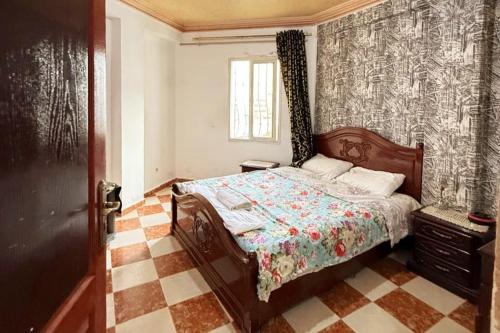 a bedroom with a bed with a patterned wall at Luxury apartment in front of the Corniche in Tangier