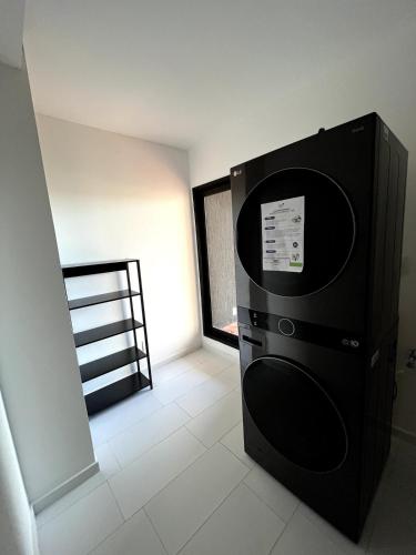a black microwave in a room with a window at Departamento amoblado en Luque in Luque