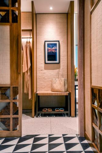 a walk in closet with a bench and a purse at South Palms Resort and Spa Panglao - MGallery Collection in Panglao