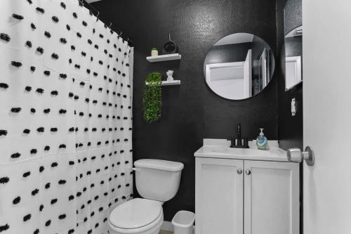 a bathroom with a white toilet and a mirror at Zebra House - Close 2 all TampaBay has to offer in Tampa