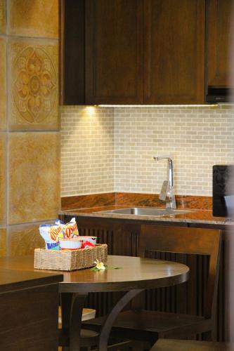 a kitchen with a table and a sink at Pandanus Resort in Mui Ne
