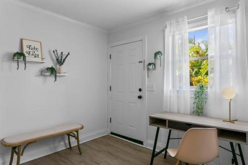 a white room with a table and a window at Boho Inspired Apt in the heart of Tampa Bay! in Tampa