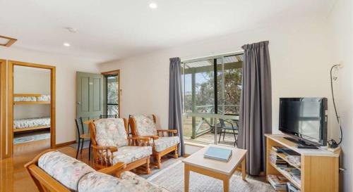 a living room with a couch and a tv at Lavender 63 Burgar Rd Middleton - Linen Included in Middleton