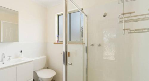 a bathroom with a shower and a toilet and a sink at Lavender 63 Burgar Rd Middleton - Linen Included in Middleton