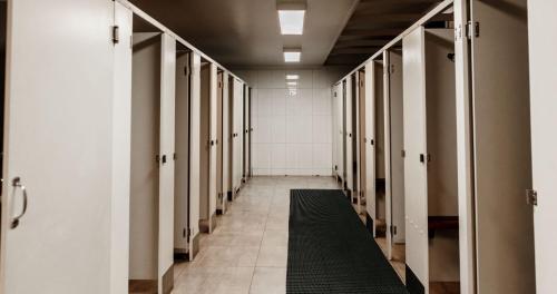 a hallway of a locker room with a black rug at BIG4 Breeze Holiday Parks - Katherine in Katherine