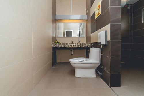 a bathroom with a toilet and a sink at d'Lux 6BR16-25px Pool BBQ NetFlx HotPot KTV Mahjong by Our Stay in Bandar Penawar