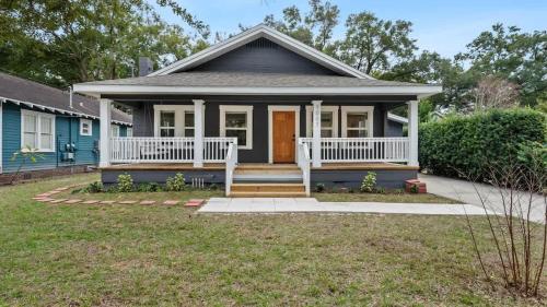 a small blue house with a front porch at Mid-Century Modern Retreat by Coffee, Food + Shops in Tampa