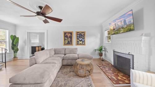 a living room with a couch and a ceiling fan at Spacious Modern Farmhouse w/ Private Patio & BBQ! in Tampa