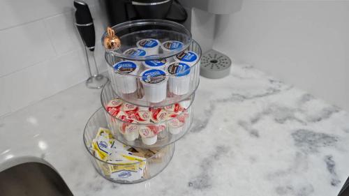 a bunch of cupcakes in a container on a counter at Modern-Retro Themed Home Close to Coffee + Food! in Tampa