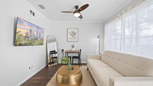a living room with a couch and a table at Comfy Modern Farmhouse Cottage w/ Private Patio! in Tampa