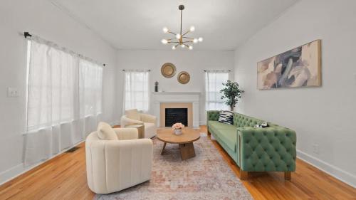 a living room with two chairs and a table at Modern Moroccan Villa w/ Firepit, BBQ + Game Room! in Tampa